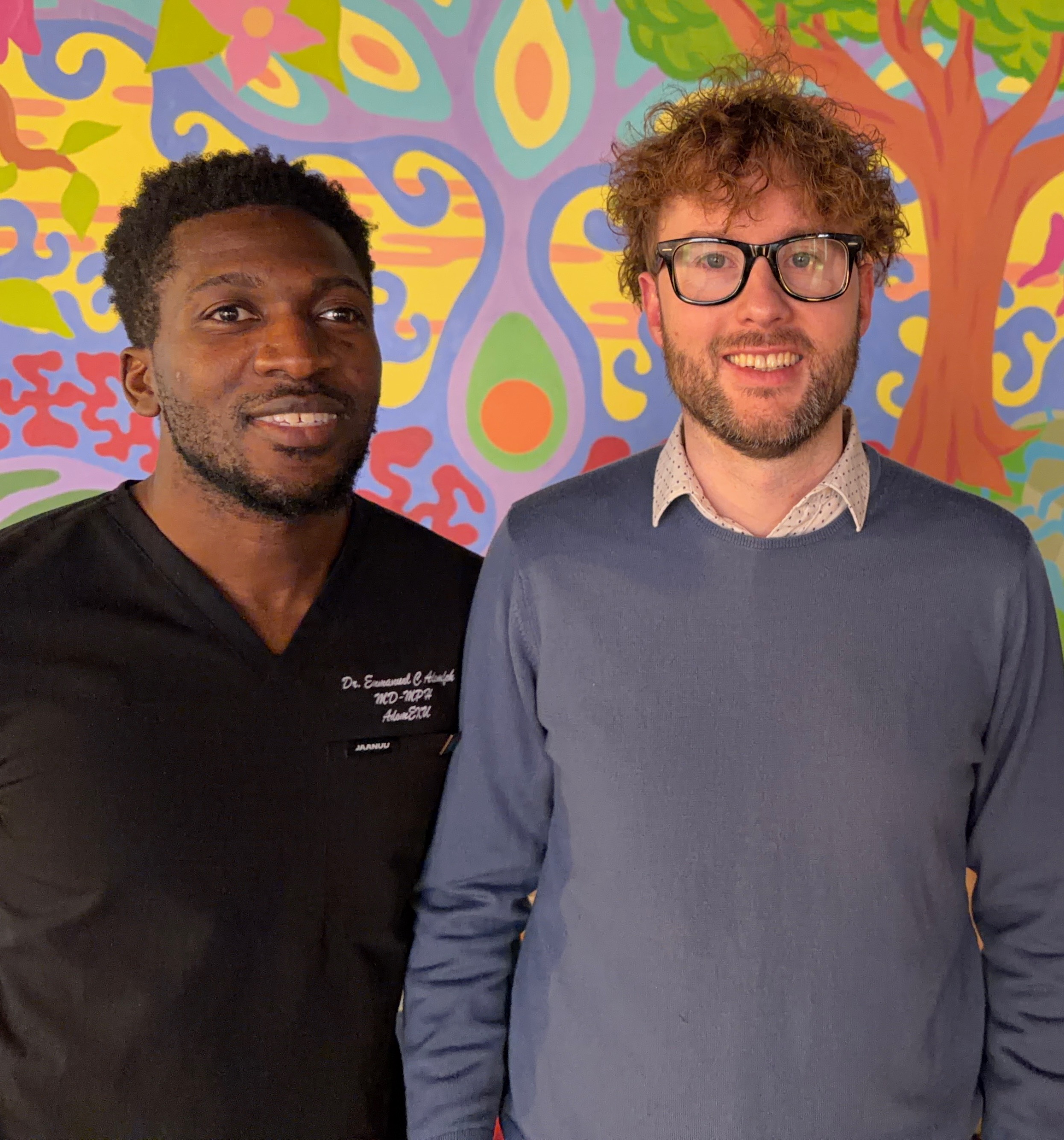 KasaMD co-founders standing together in front of a painted mural